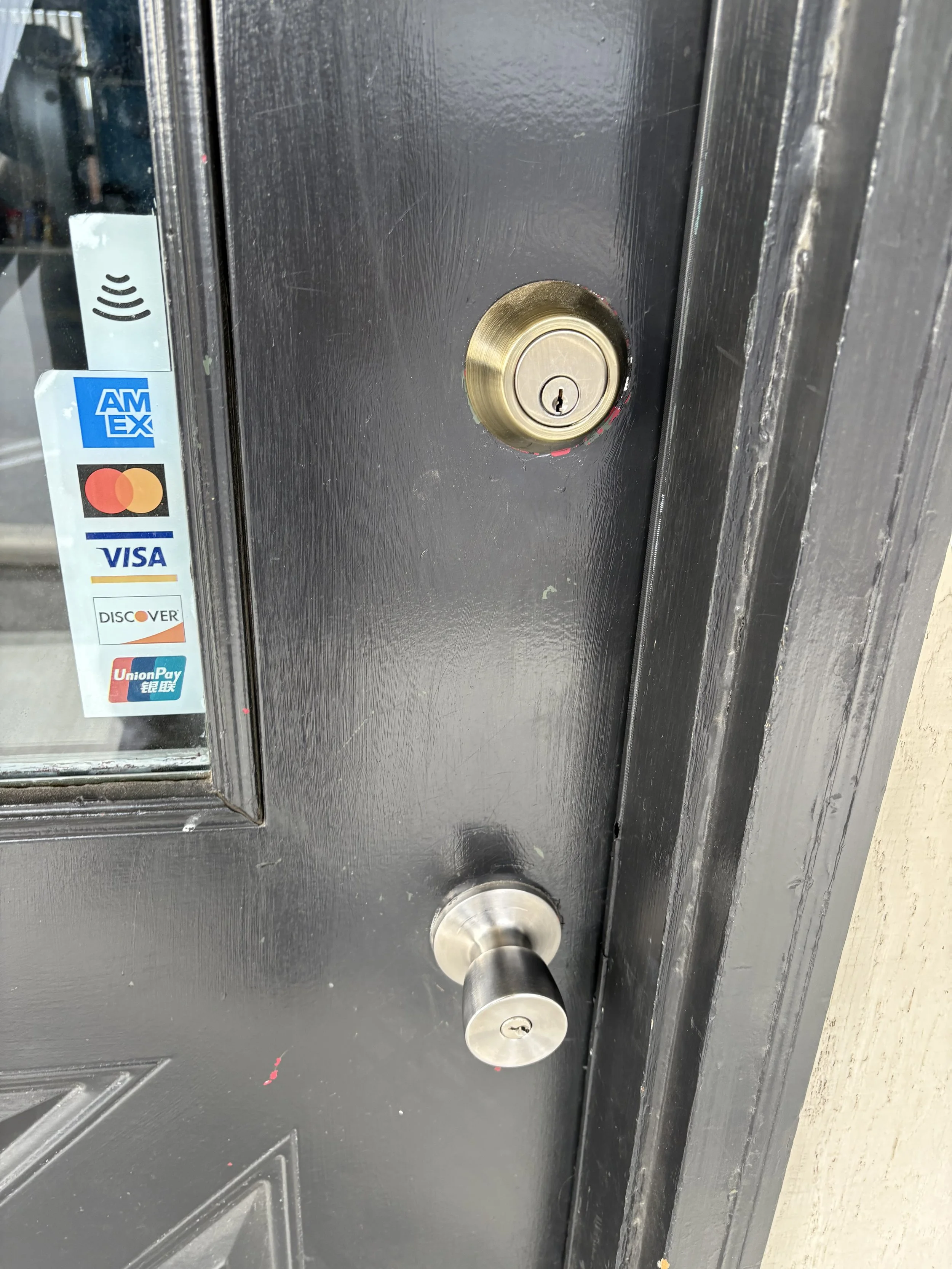 Residential door lock service on a house entry door.